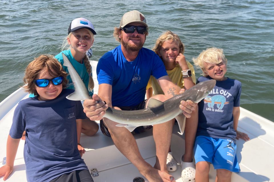Kids fishing from a Lowcountry Coastal Excursions boat