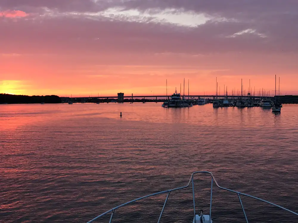 Pink sunset over Charleston Harbor from the bow of the boat