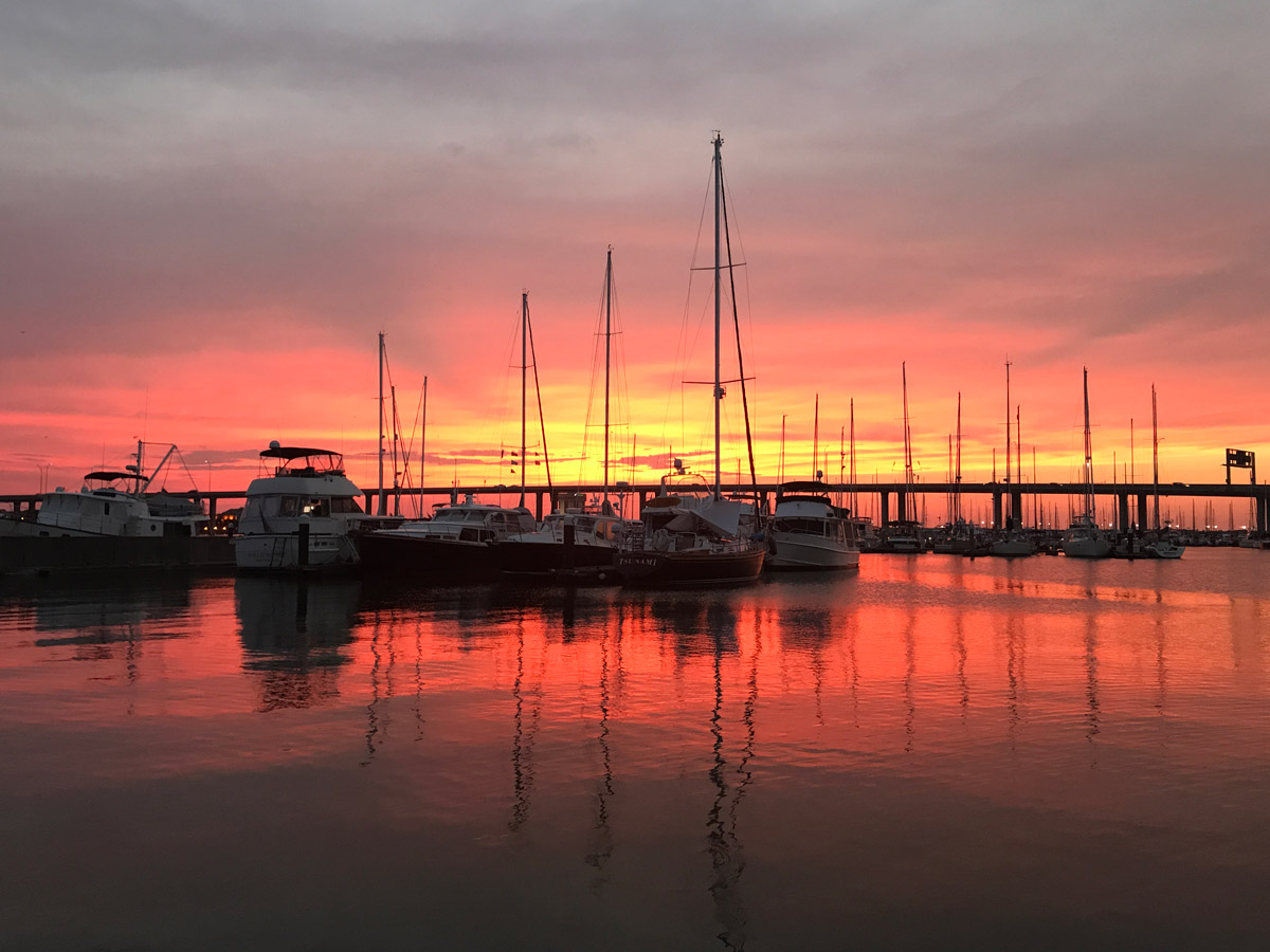 Charleston marina ablaze under a fiery red sunset